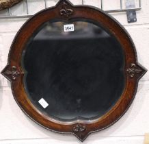 A Victorian oak framed wall mirror, having shaped and bevelled glass, overall 60 x 60 cm. Not