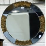 An early 20th century circular wall mirror, sectional with a blue tint mirrored and carved wood