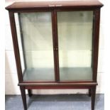 A late 19th/early 20th century door vitrine/curios cabinet, with two internal glass shelves and of
