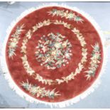 A circular Chinese thick pile red ground floor rug, fringed, D: 200 cm. Not available for in-house