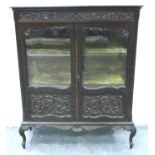 A 19th century two door glazed display cabinet, carved with two velvet lined interior shelves, 107 x