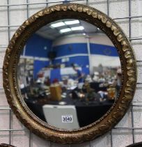 A 19th century convex circular wall mirror with a gilt carved wood frame, overall D: 50 cm. Not