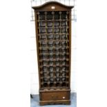 A contemporary stained pine wine rack for 48 bottles, with single drawer below, 57 x 37 x 169 cm