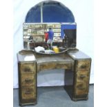 An Art Deco period walnut dressing table, with inverted bow front and oversized mirror, 114 x 53 x