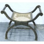 A 20th century stained and distressed pine savoronola stool with bergere seat. Not available for