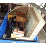 Box of mixed items to include books, paintings and an Australian sun hat etc. Not available for in-