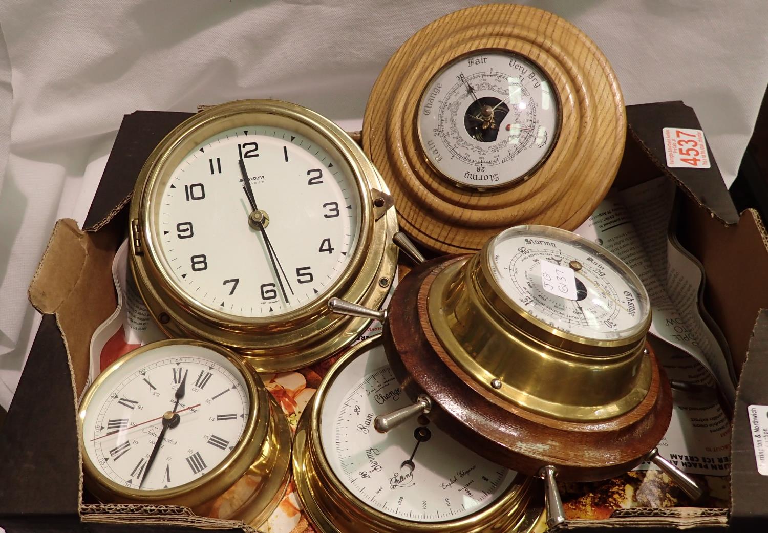 Tray of Marine style brass effect clocks and barometers, working at lotting. Not available for in-