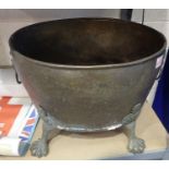 Large brass log bucket with lion head handles and paw feet, H: 30 cm. Not available for in-house P&