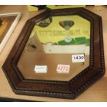 Oak framed octagonal mirror with bevelled edge glass, 32 x 45 cm. Not available for in-house P&P,