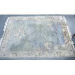 Large Chinese pure wool fringed rug green and beige ground with floral design, 274 x 170 cm. Not