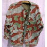 German WWII 1944 dated camouflage smock, de-badged bearing stamps inside, some areas of damage,
