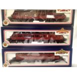 Three OO scale Bachmann BR MK1 Suburban coaches; open and brake end and a parcels van. All maroon,