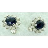 18ct white gold pair of stud earrings, each set with a cluster of blue topaz and diamonds,