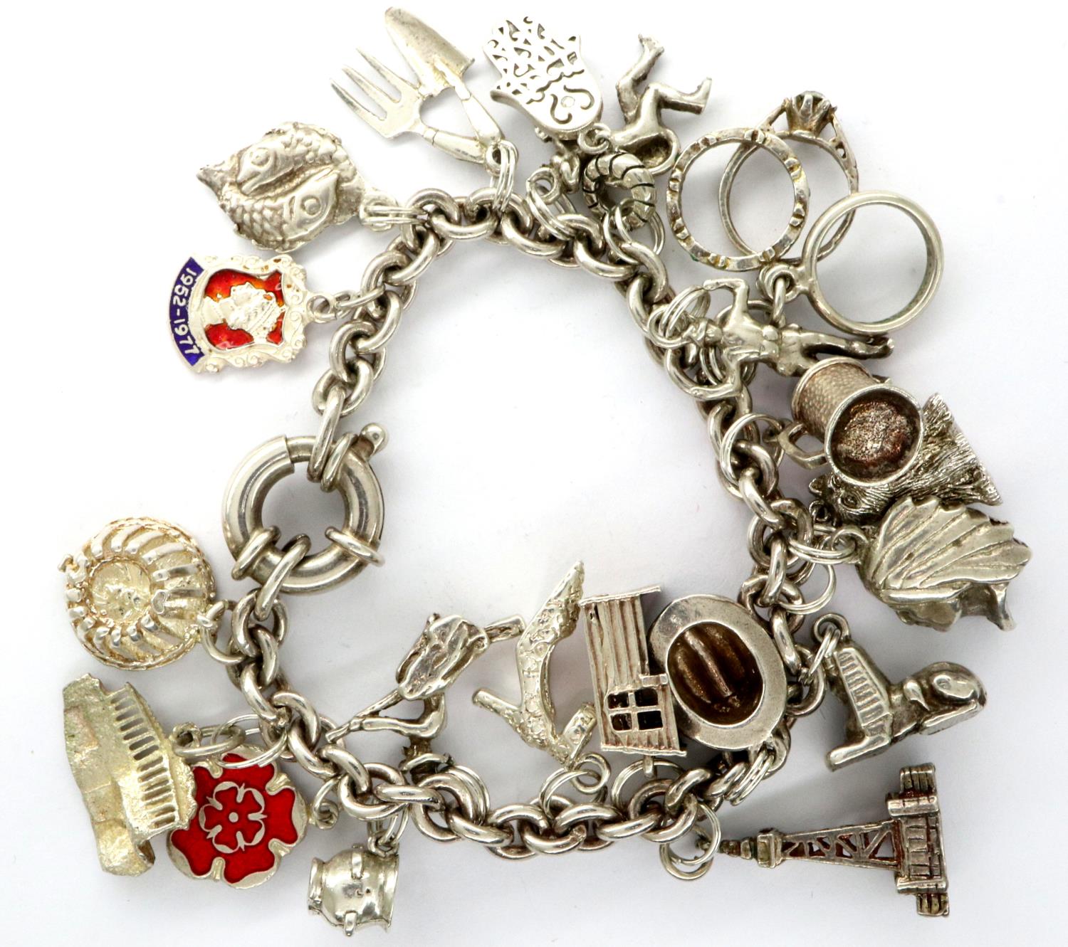 925 silver charm bracelet with twenty charms, L: 18 cm, combined 67g. P&P Group 1 (£14+VAT for the