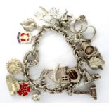 925 silver charm bracelet with twenty charms, L: 18 cm, combined 67g. P&P Group 1 (£14+VAT for the