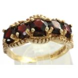 9ct gold ring set with five garnets, size O, 3.2g. P&P Group 1 (£14+VAT for the first lot and £1+VAT