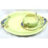 Clarice Cliff meat plate and a gravy boat with stand, plate L: 38 cm. Crazing to all items some