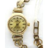 9ct gold ladies Perina wristwatch on a 9ct gold bracelet, working at lotting, 9.7g. P&P Group 1 (£