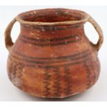 A Neolithic period vessel, having twin incorporated handles and retaining much of its original