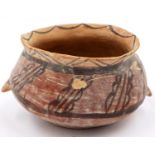 A Neolithic period painted terracotta twin handled pot, decorated with geometric designs, painted