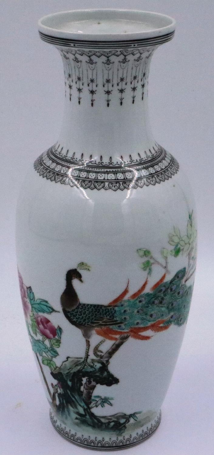 An early 20th century Chinese Republic porcelain vase, glazed and decorated with a peacock within