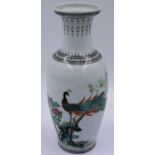 An early 20th century Chinese Republic porcelain vase, glazed and decorated with a peacock within