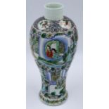An 18th / 19th century enamelled porcelain vase of elongated baluster form, decorated with panels of