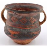 A Neolithic period painted terracotta twin handled pot, decorated with geometric designs, painted