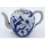 An early 19th century porcelain teapot, decorated in blue over a white ground, with bamboo style
