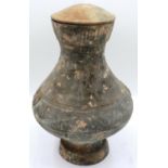 A Han Dynasty covered jar or Hu, thrown in grey clay with moulded and applied faux-handles, H: 44 cm