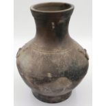 An early Qing Dynasty grey clay jar, baluster form with integral faux ring handles, footed base