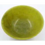 A Chinese carved jade or similar bowl, D: 12 cm, H: 5 cm. Small chip to rim. P&P Group 2 (£18+VAT