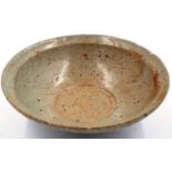 A Song Dynasty glazed bowl, near celadon in colour, D: 16 cm, H: 6 cm. Some chips to the rim and