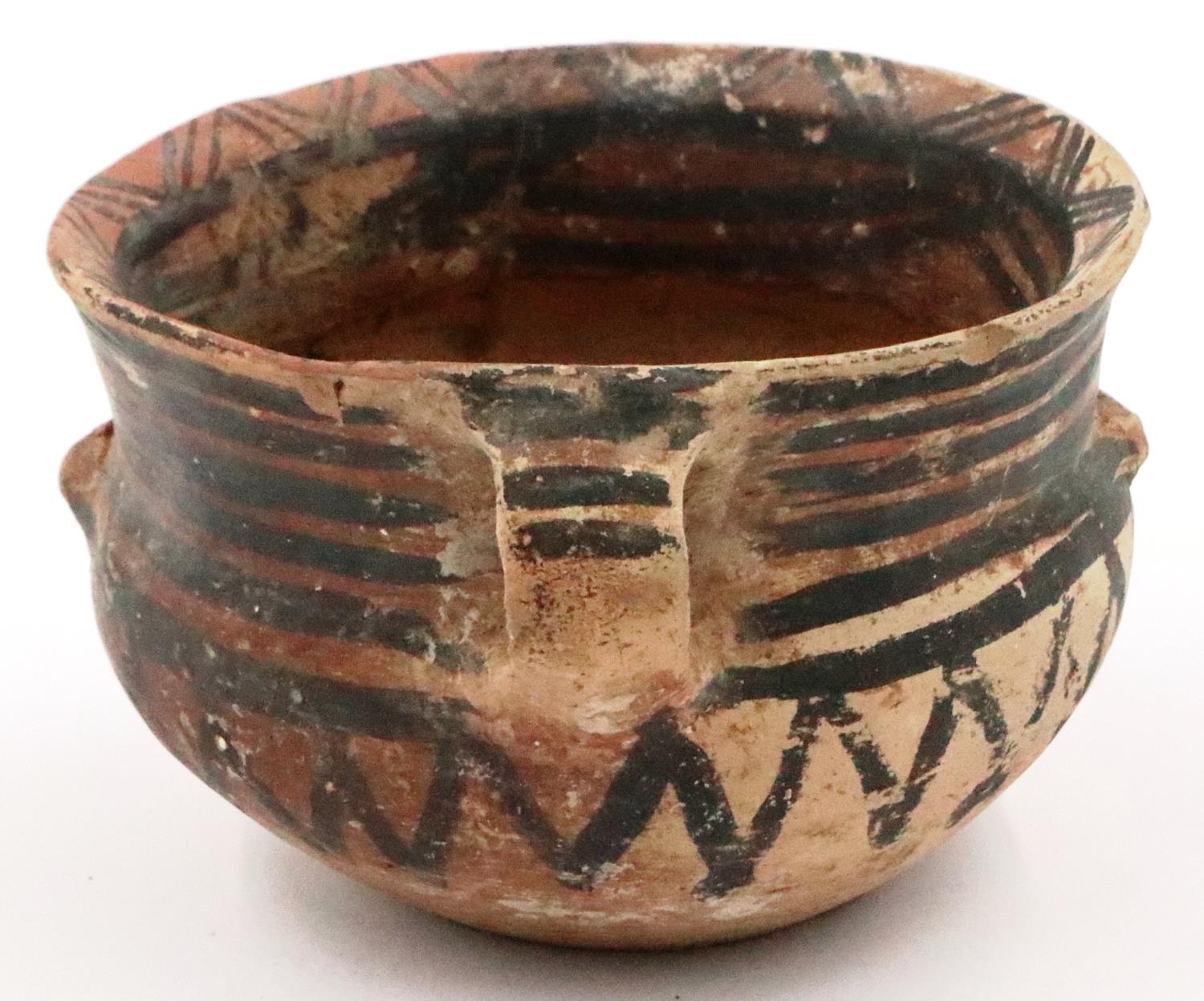 A Neolithic period painted terracotta twin handled pot, decorated with geometric designs, repaired - Image 3 of 9