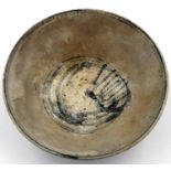 A Ming Dynasty glazed pottery bowl, footed and with painted characters to the base D: 13 cm. P&P