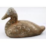 A Han Dynasty zoomorphic candle holder in the form of a duck, still retaining most of its polychrome