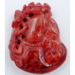 A carved red jade panel, decorated with a prowling leopard, 5 x 4 cm. P&P Group 2 (£18+VAT for the