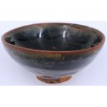A Song Dynasty black glazed bowl, footed, D: 10 cm, H: 4 cm. P&P Group 2 (£18+VAT for the first