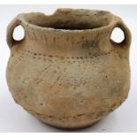 A Neolithic period urn or vessel, unusually decorated with incised decoration and unpainted,