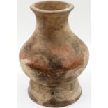 A Chinese Neolithic period vessel, retaining some of its polychrome decoration with flared neck
