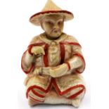 An early 20th century Chinese Republic seated figure with nodding head, wearing traditional