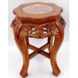 A 20th century stained and carved wood vase stand, the top inset with a circular panel of rouge