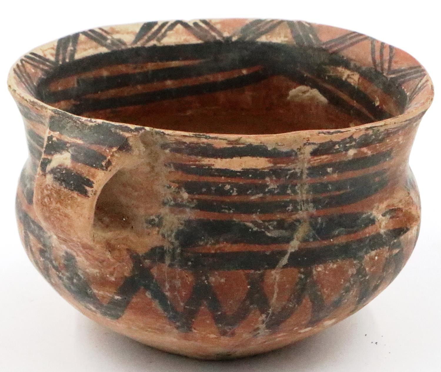 A Neolithic period painted terracotta twin handled pot, decorated with geometric designs, repaired - Image 4 of 9