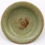 A Ming Dynasty celadon glazed shallow dish or stand, D: 12 cm, H: 3 cm. P&P Group 2 (£18+VAT for the