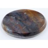 An oval block of brown agate, coloured with purple shades, polished and bevelled, 9 x 6.5 x 2 cm