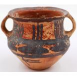 A Neolithic period painted terracotta twin handled pot, decorated with geometric designs, H: 8 cm,