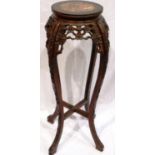 A 19th century padouk wood vase stand, heavily carved with cross stretchers and rouge marble inset