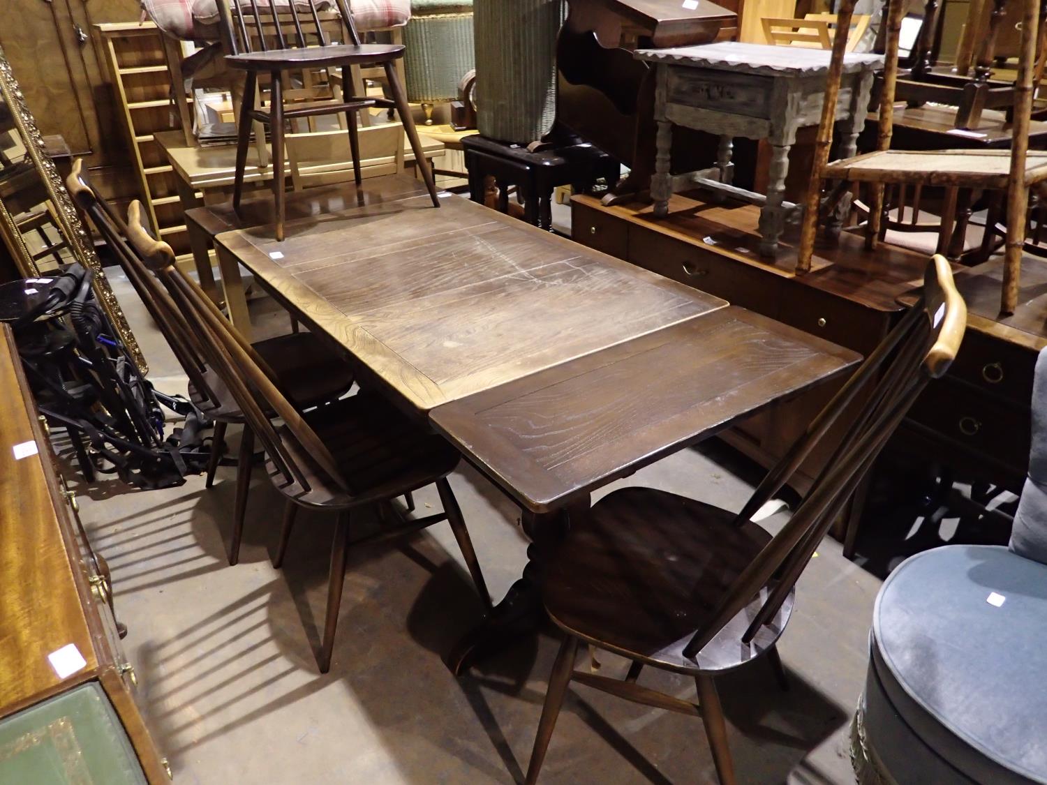 Ercol elm draw leaf dining table with four chairs. Not available for in-house P&P