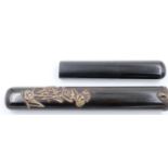 A rare Japanese Meiji period two-section lacquered bamboo pipe case, surmounted with two bronze