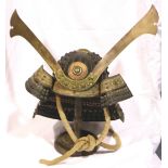 A Japanese Meiji period Kabuto with lacquered brass mounts and steel frame, with a bound-rope chin